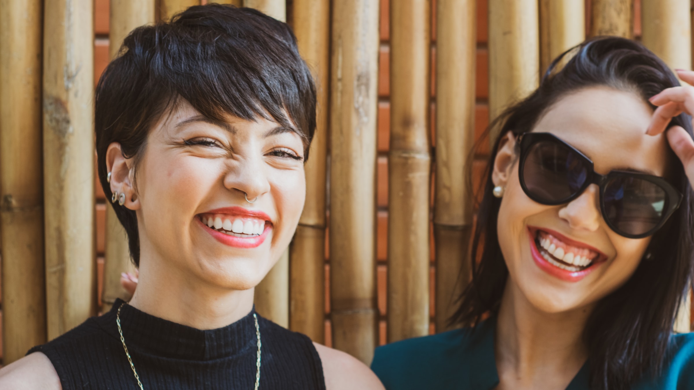 tow women standing and laughing